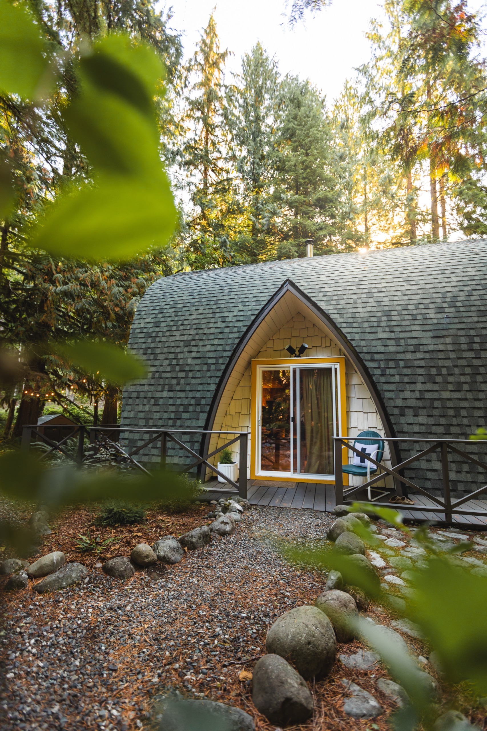 The Arch House front entry framed by forest greenery